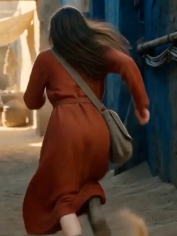 Pamela running down a blue-washed alley, seen from behind